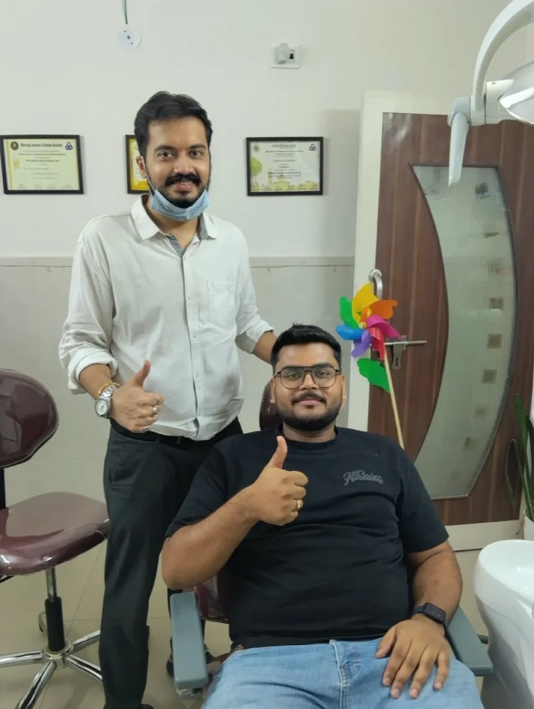 Family dental care patient giving thumbs up with Dr. Rijul