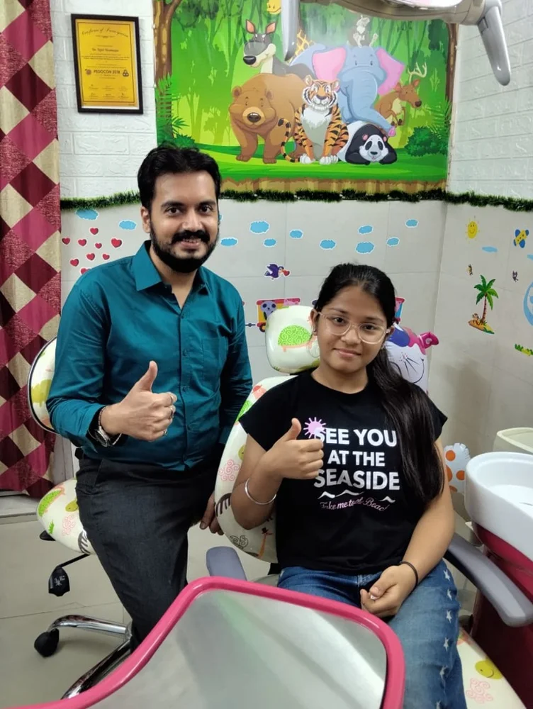 Happy pediatric dental patient with Dr. Rijul in Janakpuri